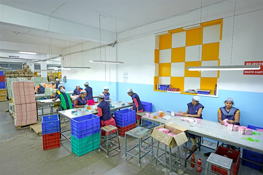 Staff hand-finishing and packing product on the floor